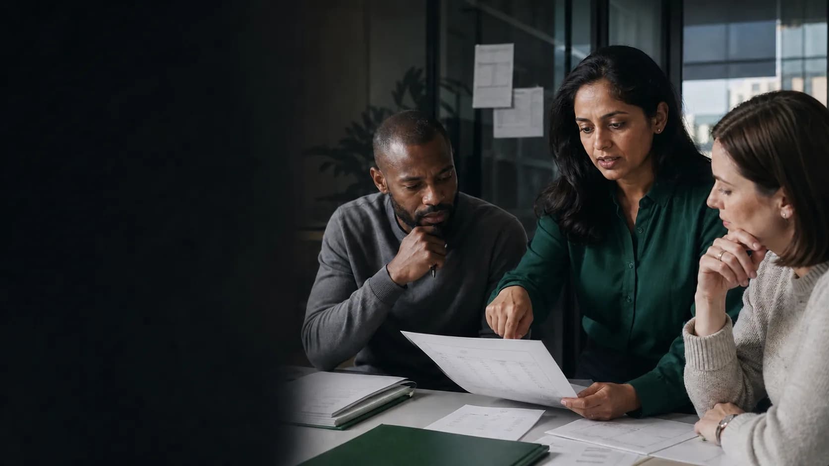 A finance operations leader and colleagues reviewing billing details together